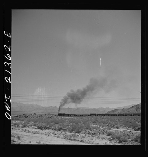 Untitled photo, possibly related to: Kingman (vicinity), Arizona. A train on the Atchison, Topeka and Santa Fe Railroad between Seligman, Arizona and Needles, California going around a curve in the Walapai flats