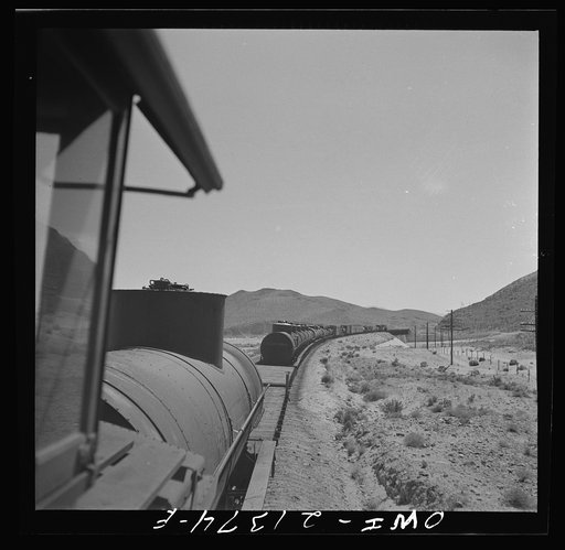Topock (vicinity), Arizona. A local freight train going around a curve on the Atchison, Topeka and Santa Fe Railroad between Seligman, Arizona and Needles, California