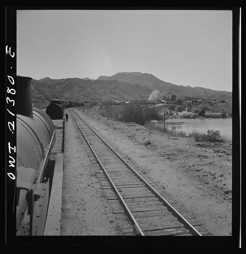 Topock, Arizona. A local freight train on the Atchison, Topeka and Santa Fe Railroad between Seligman, Arizona and Needles, California stopping at a border town to set out some cars