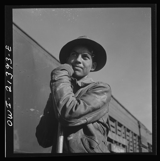 Needles, California. Young Indian worker employed on a section gang working on the tracks in the Atchison, Topeka and Santa Fe Railroad yards