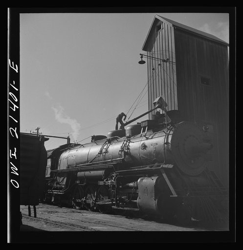 Needles, California. Filling the sand dome of a locomotive near the roundhouse in the Atchison, Topeka, and Santa Fe Railroad yard