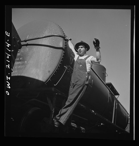 Needles, California. Switchman W.E. McCaniel at work in the Atchison, Topeka, and Santa Fe Railroad yard