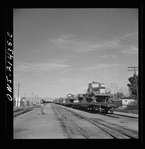 Ludlow, California. A train of military trucks and still another train waiting in the sidings because there is no room for them in the Barstow, California yard of the Atchison, Topeka, and Santa Fe Railroad