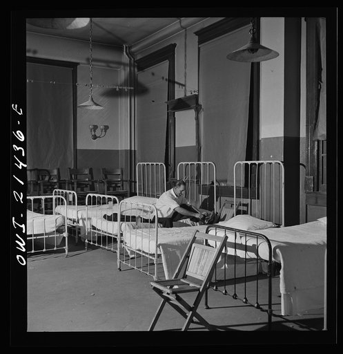 Barstow, California. Brakeman Thurston H. Lee, (whose home is in Chicago) going to bed at the reading room in Barstow, California. This room has been converted from a billiard room into a dormitory at the Atchison, Topeka, and Santa Fe Railroad yard
