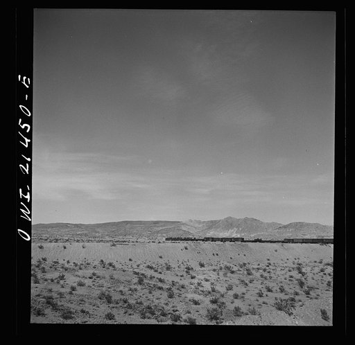 Untitled photo, possibly related to: Klondike (vicinity), California. Going around a curve on the Atchison, Topeka and Santa Fe Railroad between Needles and Barstow, California