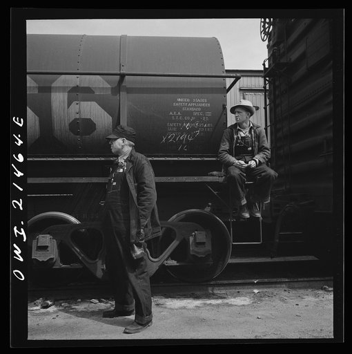 Barstow, California. Head brakeman J.C. Shannon (left) and swing brakeman, B.E. Wilson, waiting for their train to pull out of the Atchison, Topeka and Santa Fe Railroad yard
