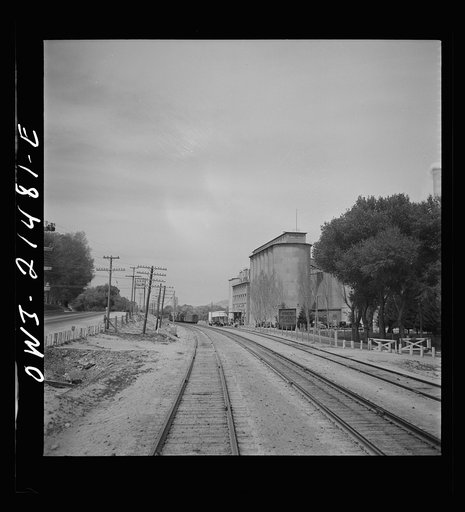 Victorville (vicinity), California. Passing a Portland cement plant along the Atchison, Topeka and Santa Fe Railroad between Barstow and San Bernardino, California