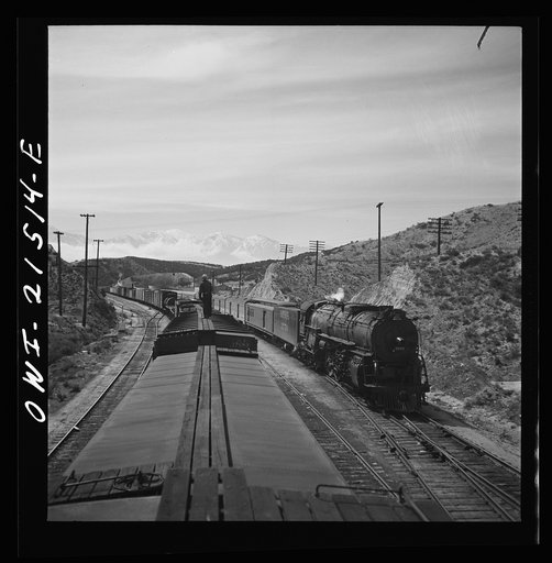 Summit (vicinity), California. Passing an eastbound passenger train, the Chief, while coming down the mountain on the Atchison, Topeka, and Santa Fe Railroad between Barstow and San Bernardino, California