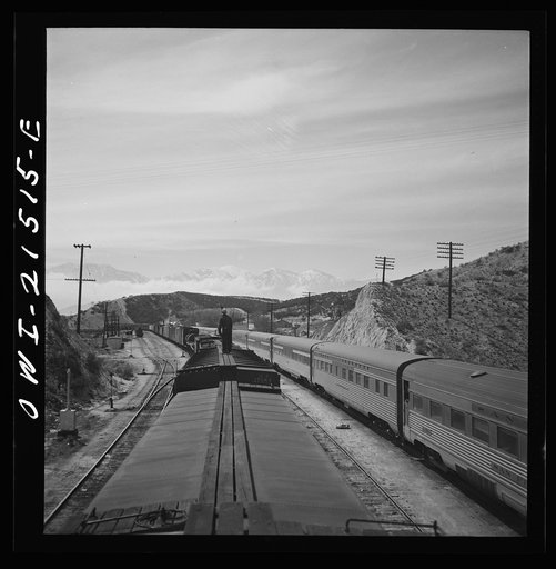 Summit (vicinity), California. Passing an eastbound passenger train, the Chief, while coming down the mountain on the Atchison, Topeka, and Santa Fe Railroad between Barstow and San Bernardino, California