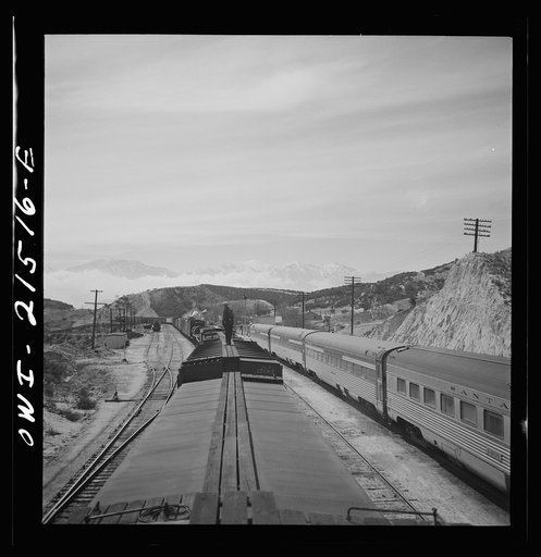 Untitled photo, possibly related to: Summit (vicinity), California. Passing an eastbound passenger train, the Chief, while coming down the mountain on the Atchison, Topeka, and Santa Fe Railroad between Barstow and San Bernardino, California