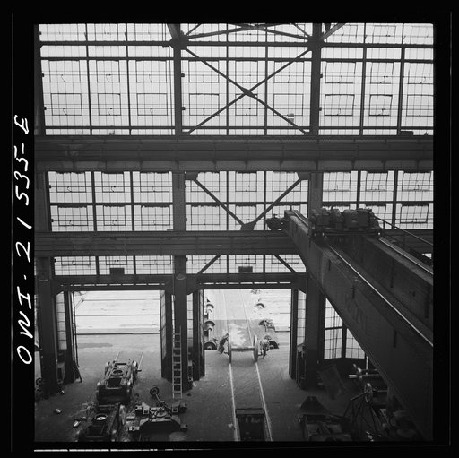 Untitled photo, possibly related to: San Bernardino, California. Rolling in the wheels for an engine to be wheeled at the Atchison, Topeka, and Santa Fe Railroad locomotive shops
