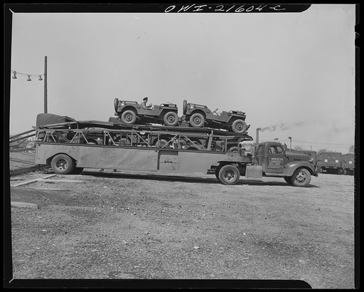 Detroit, Michigan. Loading a haulaway truck with army cars