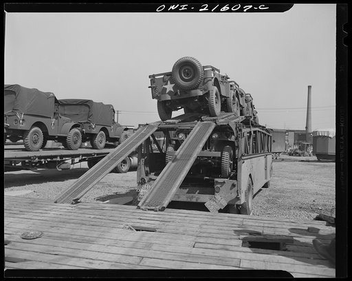 Detroit, Michigan. Loading a haulaway truck with army cars