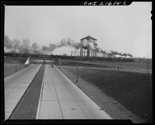 Detroit (vicinity), Michigan. Freight train crossing modern overpass near Willow Run bomber plant