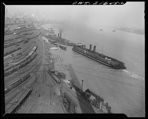 Detroit, Michigan (?). A train yard and loading docks showing two car ferries arriving at the docks