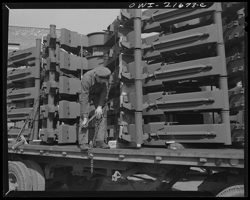Detroit, Michigan. Tightening chains holding gun mounts to floor of a truck