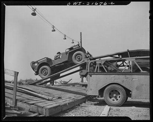 Detroit, Michigan. Driving an army car up a ramp on to the haulaway truck
