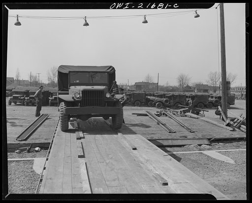 Untitled photo, possibly related to: Detroit, Michigan. Army trucks on a haulaway