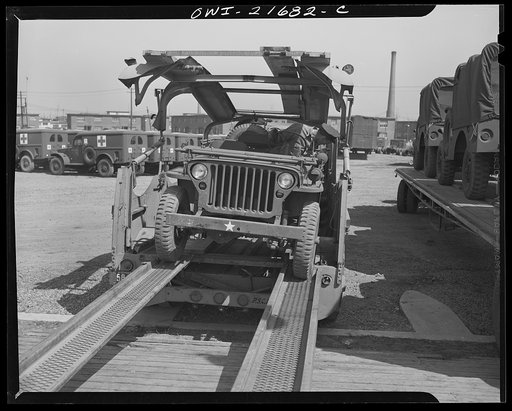 Detroit, Michigan. Backing Army car on haulaway truck
