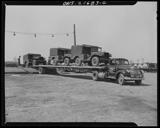 Detroit, Michigan. Driving Army trucks on haulaway truck