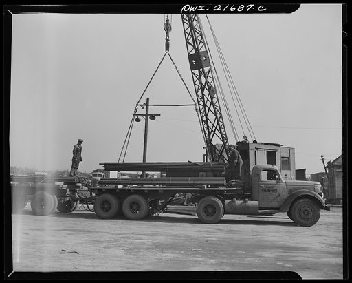 Untitled photo, possibly related to: Detroit, Michigan. Loading steel bars on a truck