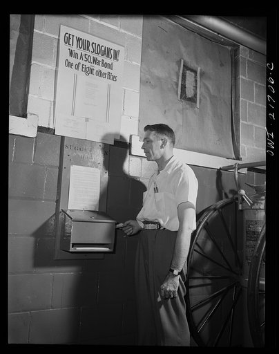 Rochester, New York. Mr. Babcock using the suggestion box at the plant to submit an idea for saving time