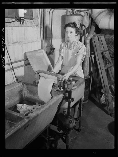 Untitled photo, possibly related to: Rochester, New York. Mrs. Babcock doing the family washing with an electric washing machine and a wringer
