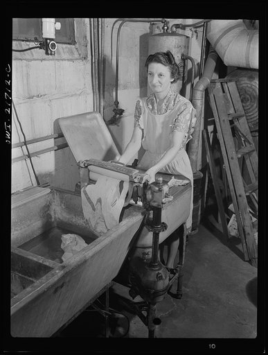 Rochester, New York. Mrs. Babcock doing the family washing with an electric washing machine and a wringer