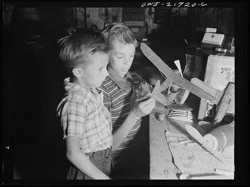 Untitled photo, possibly related to: Rochester, New York. Earl and Howard Babcock looking over one of the model airplanes which Howard built