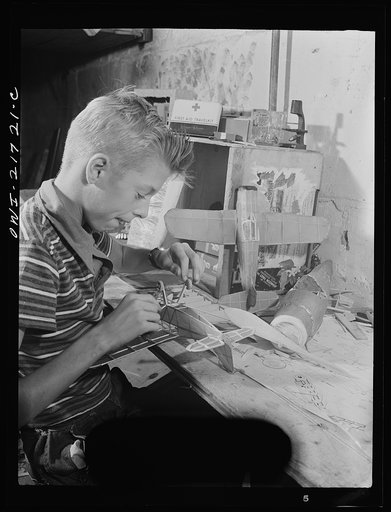 Rochester, New York. Howard Babcock hard at work on one of his model airplanes