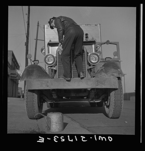 Untitled photo, possibly related to: Melvin Cash, truck driver, putting water in his radiator along U.S. Highway 29 in North Carolina enroute to Charlotte