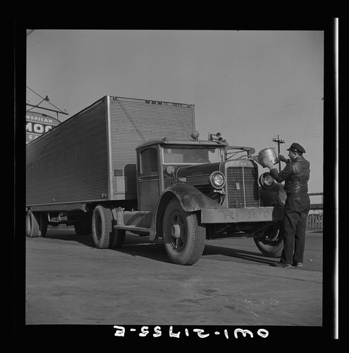 Untitled photo, possibly related to: Melvin Cash, truck driver, putting water in his radiator along U.S. Highway 29 in North Carolina enroute to Charlotte