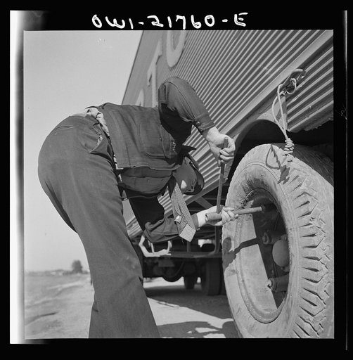 Untitled photo, possibly related to: Truck drivers changing a tire along U.S. Highway 29 in North Carolina