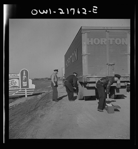 Truck drivers changing a tire along U.S. Highway 29 in North Carolina