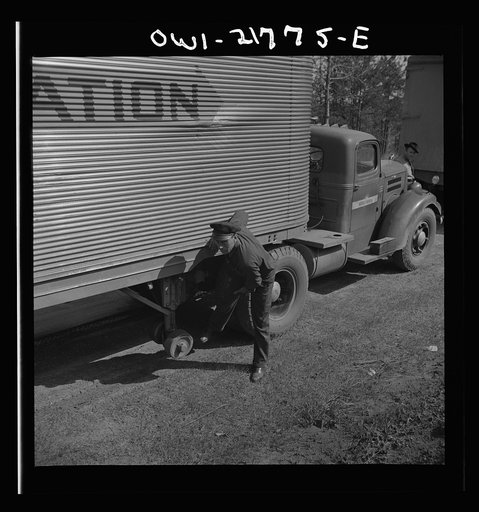 Joe Crow along U.S. Highway 29 in Georgia testing a tire by kicking it