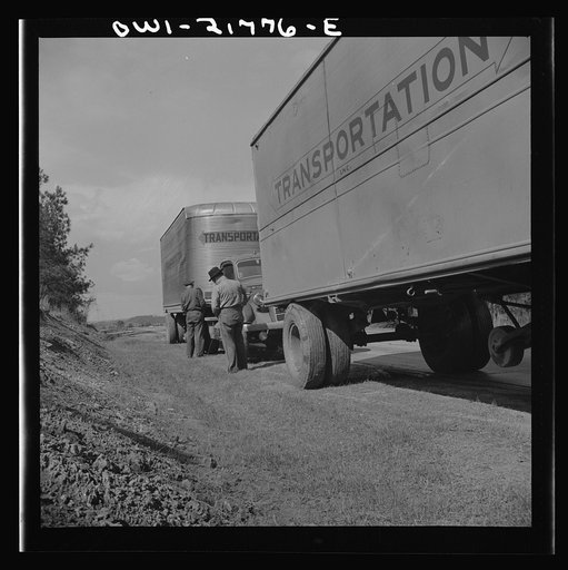 Untitled photo, possibly related to: Joe Crow along U.S. Highway 29 in Georgia testing a tire by kicking it
