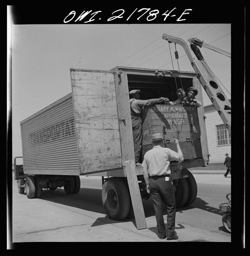 Untitled photo, possibly related to: Gunter Field, Alabama. Loading airplane motors onto a truck. They are being shipped to Macon, Georgia for repairs