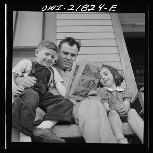 Montgomery, Alabama. Marvin Johnson, truck driver, reading "funnies" to his two children
