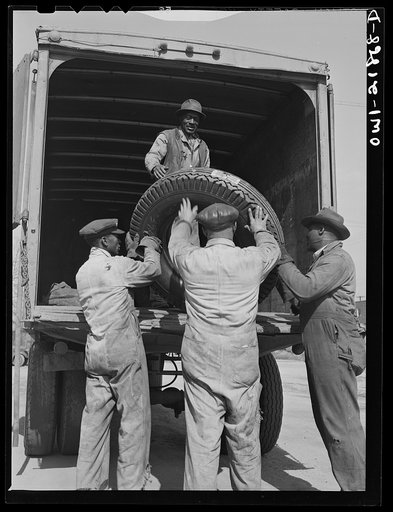 Untitled photo, possibly related to: Charlotte, North Carolina. Loading tires onto a truck at the terminal of the Associated Transport Company for shipment to other terminals