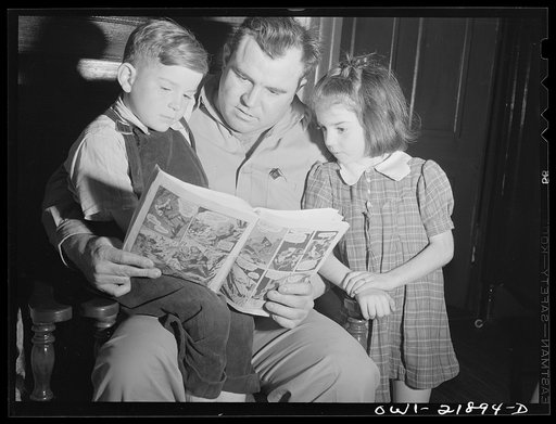 Montgomery, Alabama. Marvin Johnson, truck driver, reading "funnies" to his children