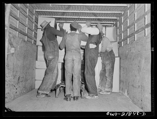 Charlotte, North Carolina. Loading a truck at the terminal of the Associated Transport Company