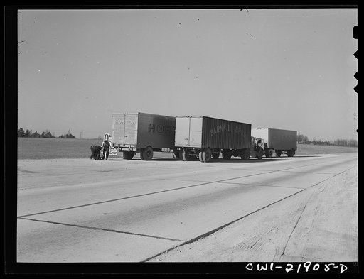 Truck drivers changing a tire along U.S. Highway 29 enroute to Charlotte, North Carolina