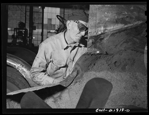 Charlotte, North Carolina. Welder at work on a truck tractor at the Brown Equipment Company