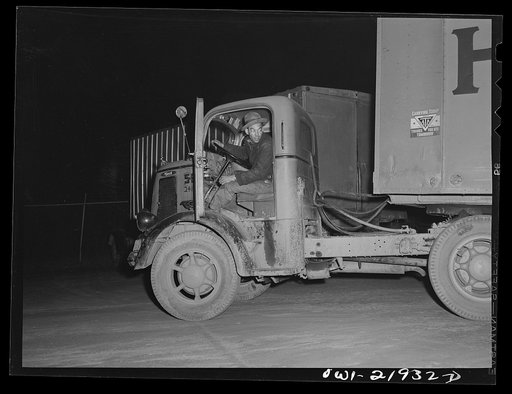 Charlotte, North Carolina. "Yard jockey" backing a truck up to the unloading platform of the Associated Transport Company