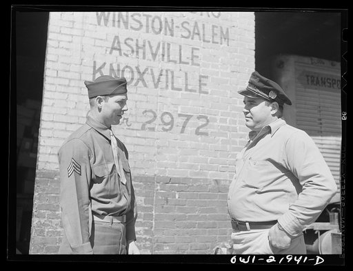Untitled photo, possibly related to: Montgomery, Alabama. Marvin Johnson talking with Seargent James Riley, who was formerly a truck driver for the Associated Transport Company