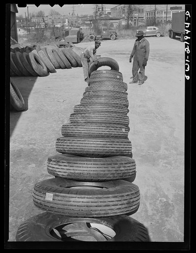 Untitled photo, possibly related to: Charlotte, North Carolina. Laying out tires which are to be branded with serial numbers at the Associated Transport Company terminal