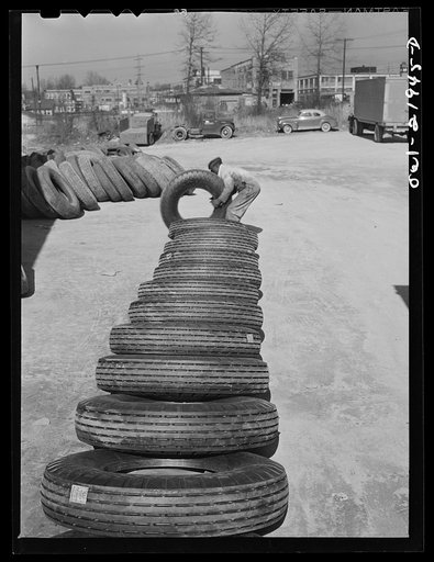 Untitled photo, possibly related to: Charlotte, North Carolina. Laying out tires which are to be branded with serial numbers at the Associated Transport Company terminal