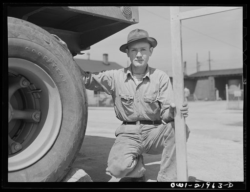 Untitled photo, possibly related to: Charlotte, North Carolina. Testing the thickness of tires at the terminal of the Associated Transport Company. This is done to make sure the tire with the thickest tread rides on the outside