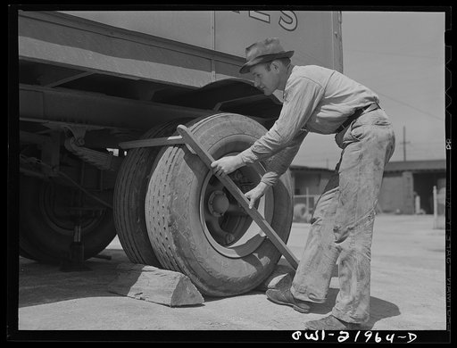 Charlotte, North Carolina. Testing the thickness of tires at the terminal of the Associated Transport Company. This is done to make sure the tire with the thickest tread rides on the outside