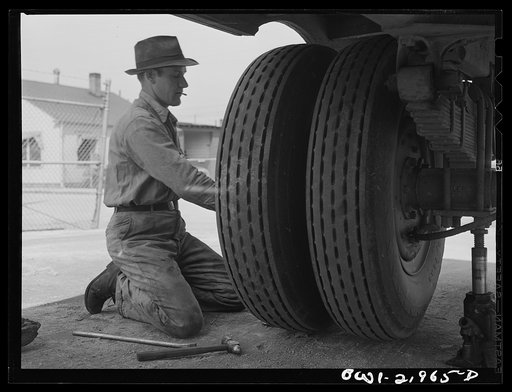 Untitled photo, possibly related to: Charlotte, North Carolina. Testing the thickness of tires at the terminal of the Associated Transport Company. This is done to make sure the tire with the thickest tread rides on the outside